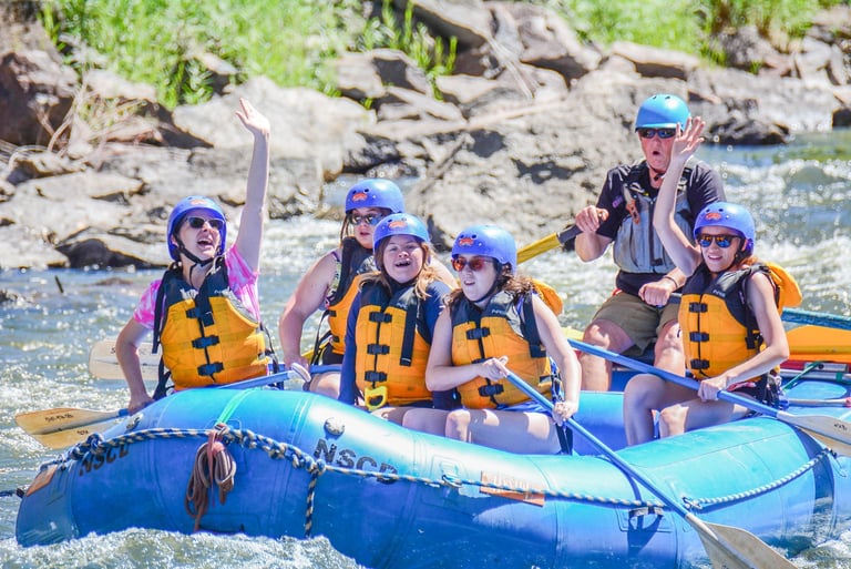 NSCD participants enjoying a whitewater rafting trip with an instructor on a Colorado river.