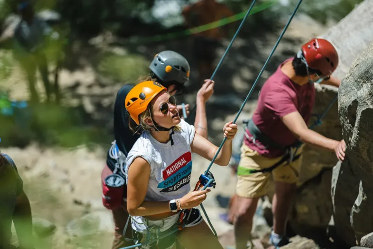 NSCD staff belaying a group of adaptive climbers