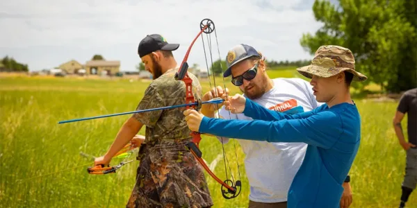NSCD Instructor with adaptive archery students