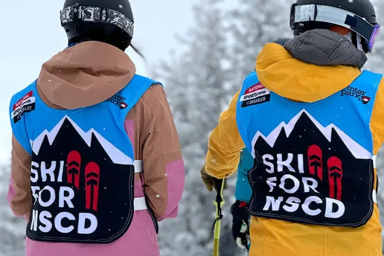 Two skiiers in Ski for NSCD bibs
